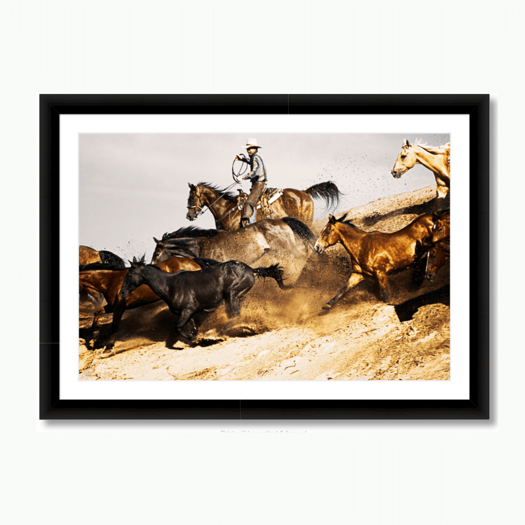 Fine art color photograph of western cowboys with charging horses for a round up by Andy Anderson