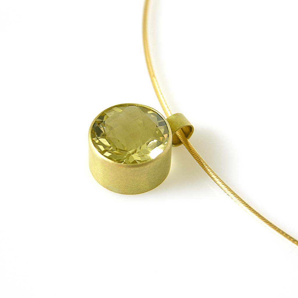 This stunning choker necklace encorporates a 14mm round lemon-quartz set in an 18k gold bezel setting with matte finish. The necklace is completed with a thick 1.2mm 18k gold cord neck wire and hook clasp.